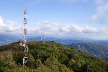 Metal structures on the top of high mountain above clouds