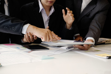 Business partner meeting and discussion with tablet and report finance paper on office desk.