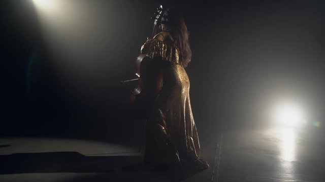 The cellist performs on stage.