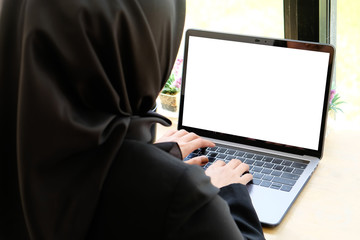 Islam woman using mockup laptop computer.