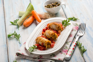 filled sepia with tomatoes capers carrots and leek