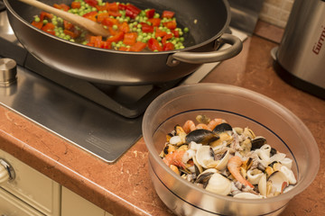 horizontal image of a pan on fire during the preparation of the paella