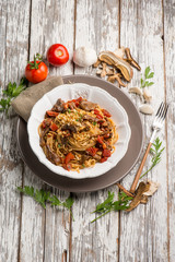 spaghetti with dried mushroom crumbs and tomatoes