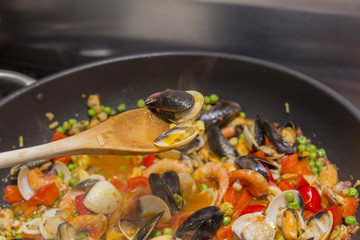 horizontal image with food detail of paella preparation