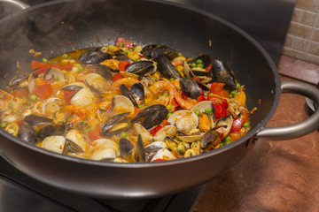 horizontal image with food detail of paella preparation