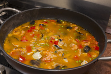 horizontal image with food detail of paella preparation