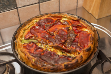 horizontal image with detail of a savory pie just taken out of the oven