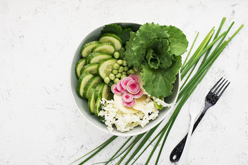 Vegetables summer fruit detox bowl. Vegetarian healthy food. Salads, lettuce leaves, raspberries, green peas, cucumber, carrots, daikon, edible flowers Top View.