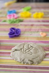 horizontal image of an educational game with magical sand and molds of various colors