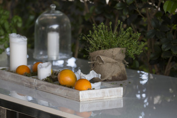 horizontal image of a white table with oranges used as decoration in a restaurant.