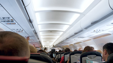Out of focus image of passengers sitting in modern jet airplane