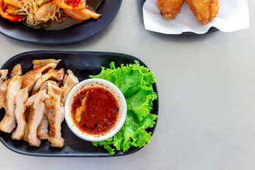 Thai food ,Tasty sliced pork on wooden board with sauce