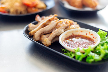 Thai food ,Tasty sliced pork on wooden board with sauce