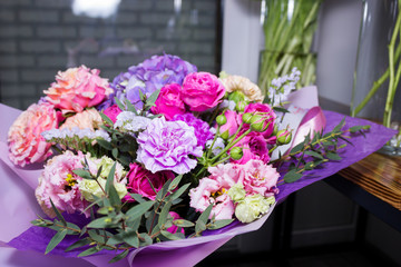 Colorful different flowers in vase at flower shop