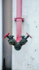 Red fire hydrant with concrete wall background