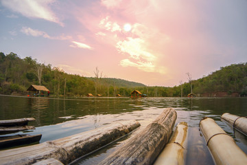 Fototapeta premium Rafting bamboo on river mountain sunset sky and cloud