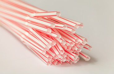 Close-up top plastic red plastic straws for drink, isolated on white background.