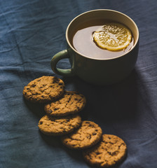 Tea with Lemon and Cookies with Chocolate Laying on Mattress
