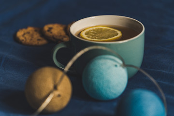 Tea with Lemon and Cookies with Chocolate Laying on Mattress