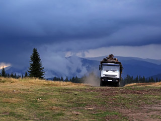 Truck transporting timber before storm