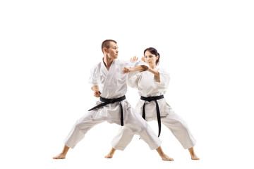 karate girl and boy fighting against white background