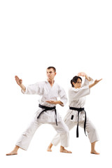 karate girl and boy fighting against white background © Nikola Spasenoski