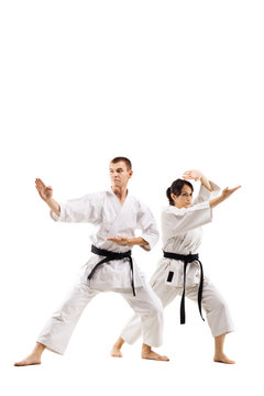 karate girl and boy fighting against white background