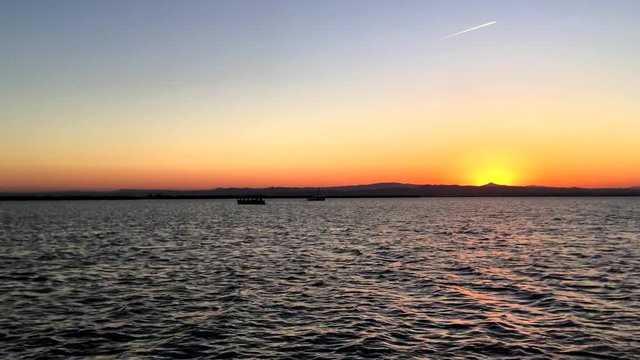 Sailing at sunset in the lagoon "La Albufera", in Valencia, Spain