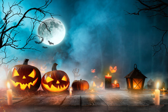 Halloween pumpkins on dark spooky forest.