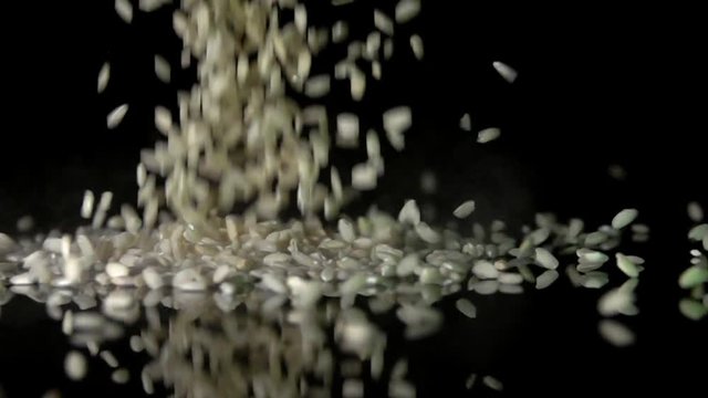 Dry Aroborio Rice Grains Falling at Black Background