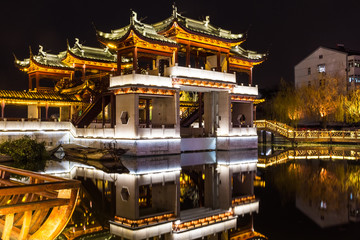 Fototapeta na wymiar Beautiful traditional monument reflection by night in Zhouzhuang, China