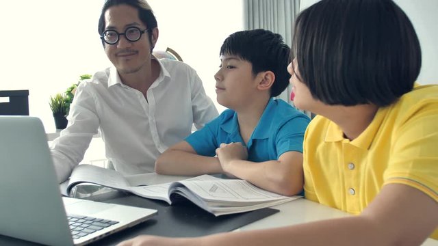 Tutor room children in class learning on laptop computer with teacher. 4K Slow motion Asian child learning with teacher at home.