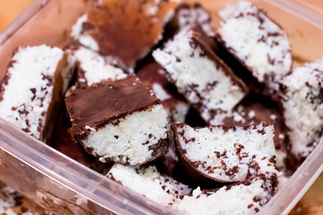 Homemade chocolate coconut bars with coconut flakes