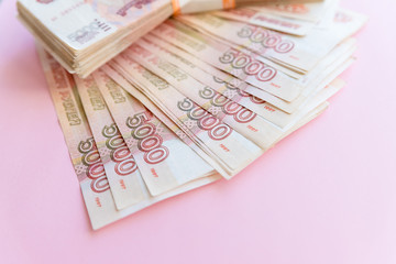 Close-up of russian banknotes. Five Thousand Ruble Notes on pink background. Copy space.many Russian banknotes.Russian Ruble.financial and wealthy concepts