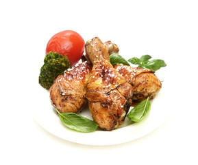 grilled chicken legs with sesame  in a  plate on a white background