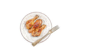 grilled chicken legs with sesame  in a  plate on a white background