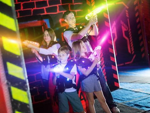 Kids and parents in beams during laser tag game