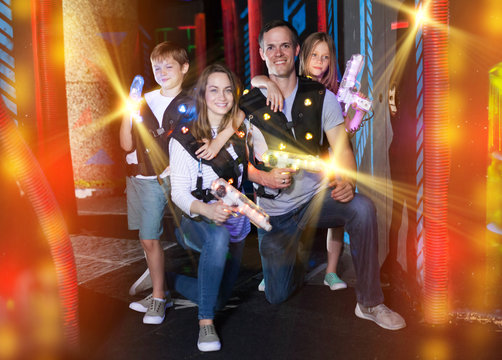 Kids and parents with laser guns in beams