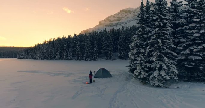 Two tourists near the tent on a snow covered landscape 4k