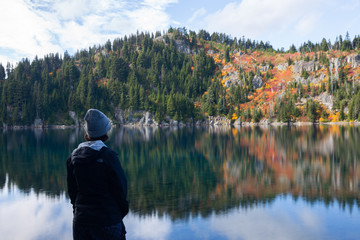 Fototapeta na wymiar Woman observing nature at a Pacific Northwest lake in fall 