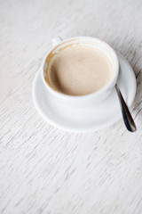Cup with a fragrant cappuccino on a wooden background