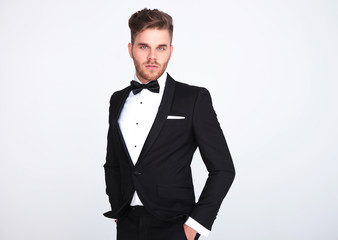 portrait of relaxed elegant man in black tuxedo