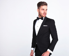side view of curious man in tuxedo looking to side