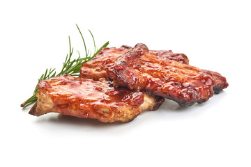 Delicious grilled pork ribs in BBQ sauce with herbs, isolated on white background.