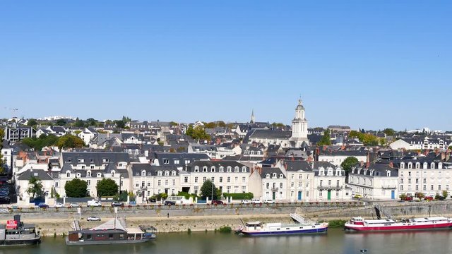 Cityscape of the city of Angers, located in western France, in the Loire Valley and the Maine-et-Loire department. This city is known as a green city. In the foreground, the Maine river is flowing.