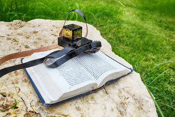 Tefillin (black leather box for Jewish prayers) and Tanakh (Hebrew Bible consisting of Torah, Neviim, Ketuvim)