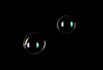 Beautiful translucent soap bubbles on dark background. Space for text