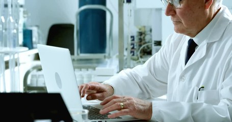 Male scientist using laptop 4k - Powered by Adobe