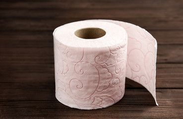 Toilet paper roll on wooden background. Personal hygiene