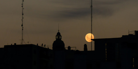 Barolo Building at dusk with full moon in Buenos Aires, Argentina. 